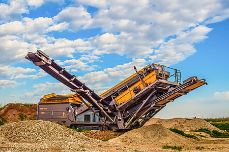 black and yellow heavy equipment under blue cloudy sky thumbnail