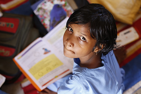 girl in blue dress reading book thumbnail