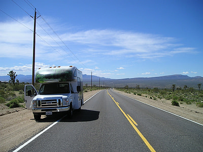 white Ford class C motorhome parked near road thumbnail