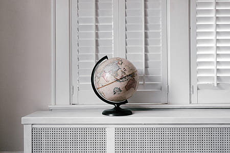 white desk globe near window thumbnail