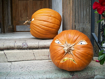 two pumpkins beside door thumbnail