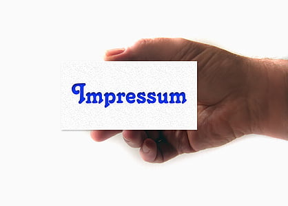 person holding Impressum-printed card thumbnail