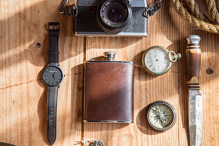 brown hip flask beside pocket watch and compass thumbnail