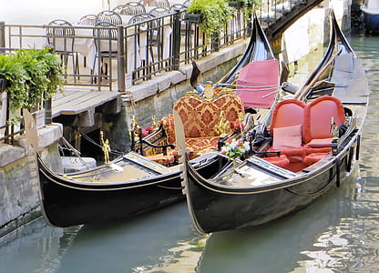 two brown wooden boats with fabric sofas on body of water thumbnail