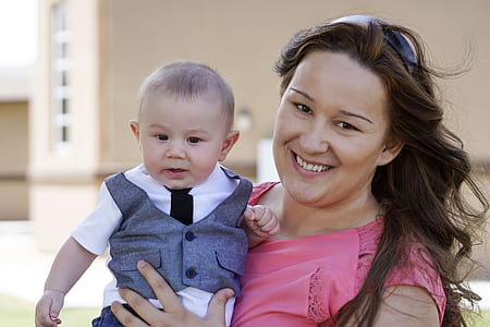 woman carrying baby smiling thumbnail