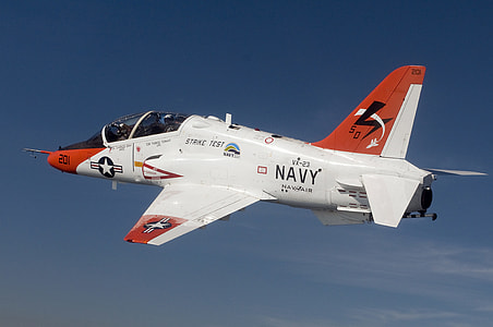 white and orange Navy fighter jet flying in the sky during daytime thumbnail