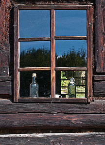 two glass bottles near windowpane thumbnail