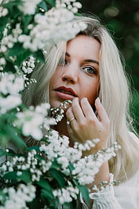 woman's face beside white petal flower thumbnail