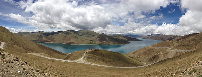 body of water surrounded by land during day thumbnail
