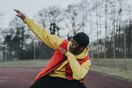 man in orange vest and yellow jacket thumbnail