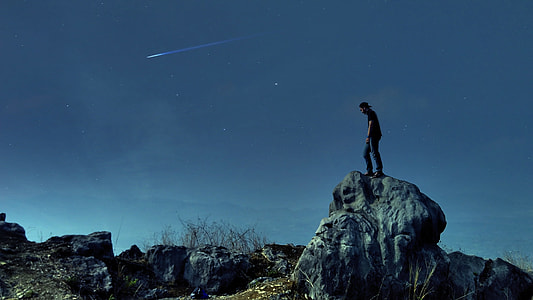 man standing on rock formation thumbnail
