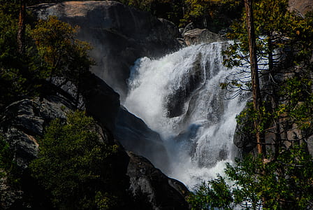 body of water on rock formation near tress thumbnail