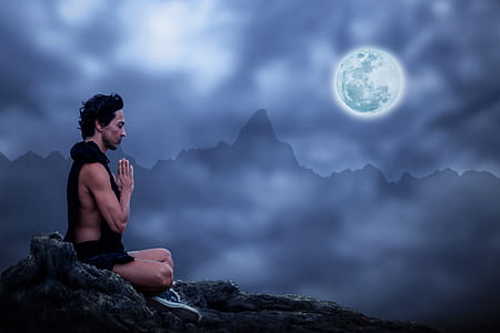 man sitting on mountain meditating thumbnail
