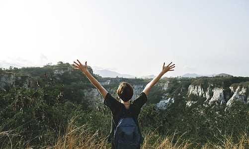 person wearing black shirt and blue leather bag raising hands on air during daytme thumbnail