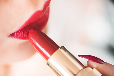 Young Woman Applying Red Lipstick thumbnail