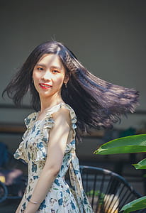 Photo of Woman in White and Blue Floral Dress thumbnail