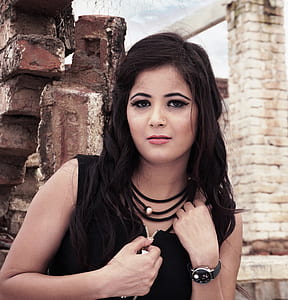 woman holding black zip-up top thumbnail