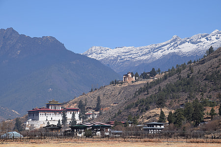 white building near hill thumbnail