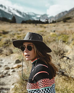 selective focus photography of woman wearing cowboy hat thumbnail