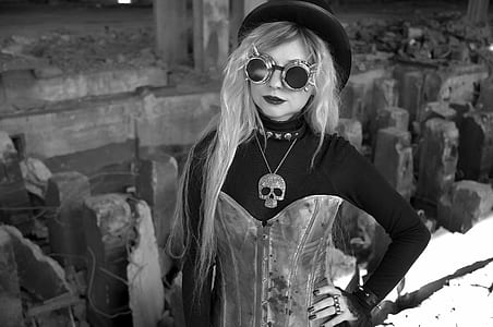 grayscale photo of woman wearing sunglasses and skull pendant necklace thumbnail