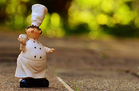 ceramic chef figurine on brown surface thumbnail