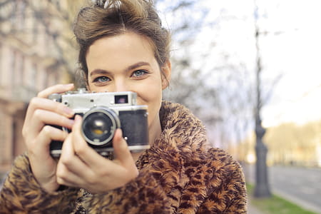 Woman Holding Black and Gray Camera Focus Photo thumbnail