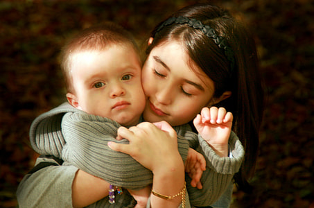 girl and baby hugging thumbnail