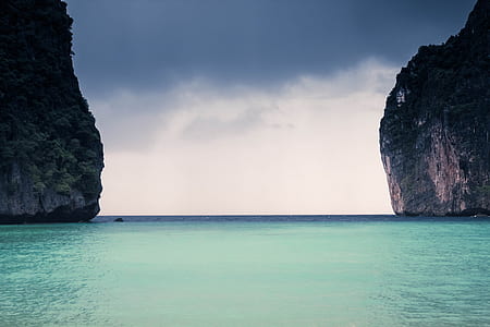 blue body of water under grey cloudy sky thumbnail