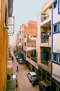white hatchback parked near building thumbnail