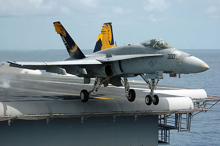 gray fighter jet surrounded by sea during daytime thumbnail