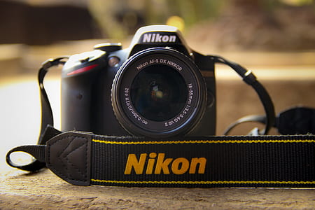 black Nikon DSLR camera thumbnail