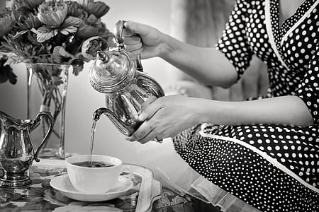 grayscale photo of person holding teapot thumbnail