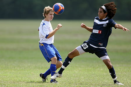 two soccer players on grass field thumbnail