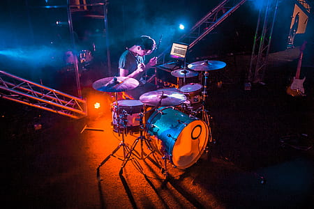 man holding drumsticks playing drum thumbnail