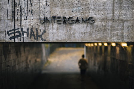 person under Untergang road tunnel selective-focus photography thumbnail