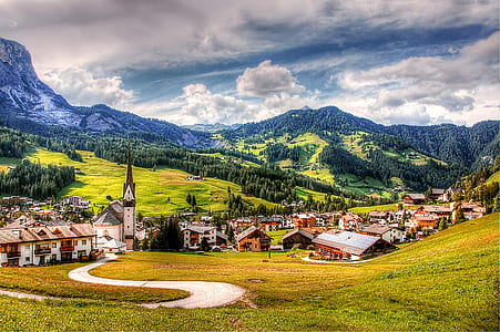 houses near mountain under gray cloudy sky thumbnail