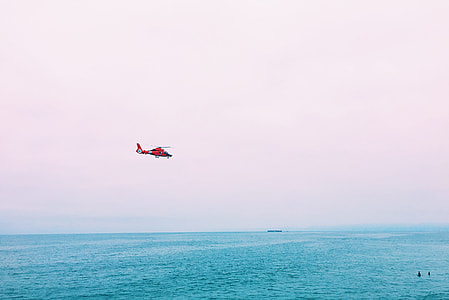 flying helicopter above body of water at daytime thumbnail