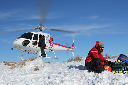 man riding in helicopter during daytime thumbnail