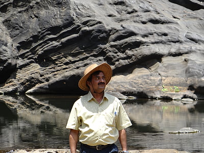 man standing in front of body of water thumbnail