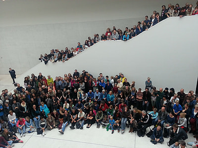 group of people inside the white building thumbnail