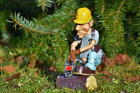 man wearing blue shirt and holding chain saw figurine thumbnail