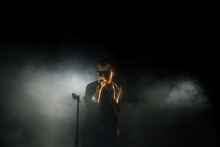 man wearing black sunglasses using microphone thumbnail