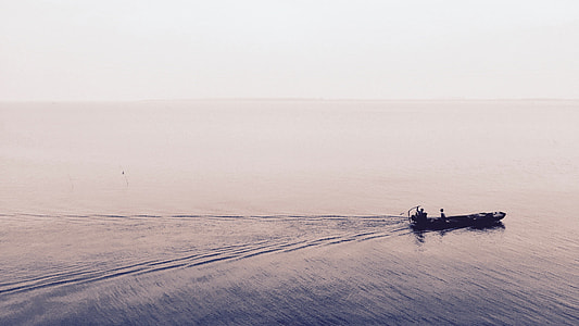 boat on calm body of water thumbnail