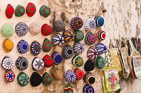 assorted-color cap and bag on wall thumbnail