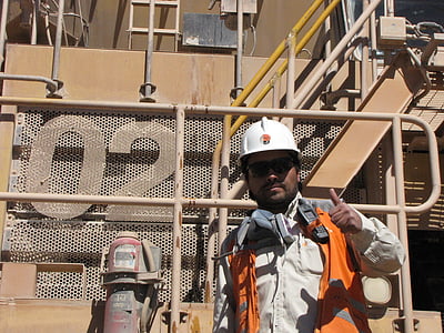 man standing near brown metal stairs thumbnail
