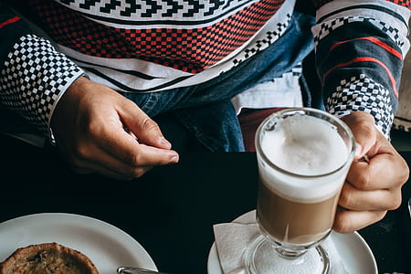 person holding glass cup thumbnail