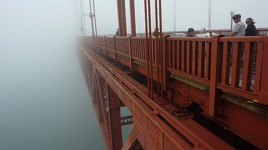 two men and one woman standing beside bridge thumbnail
