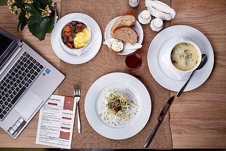 bread, soup, and vegetable dishes on table thumbnail