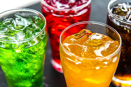 Four Clear Drinking Glasses Filled With Beverages thumbnail