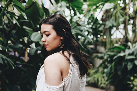 woman in white top near plants thumbnail